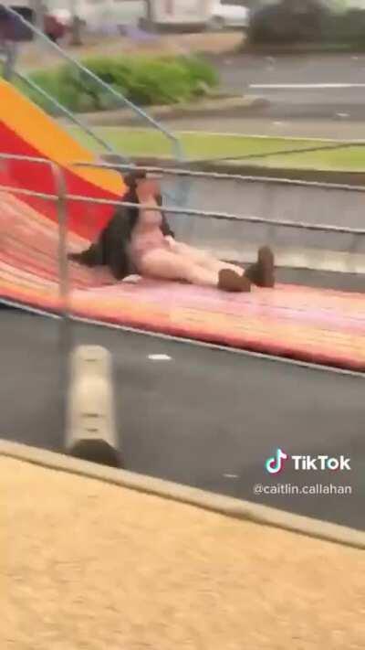 Going down a wet deserted slide onto wet cement. Looks like she left her skin on the floor.