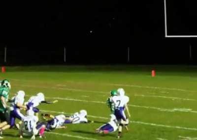 Players help an 8 year old kid with Down Syndrome score by faking trying to tackle him.