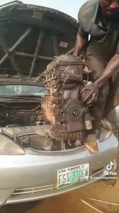 Nigerian Mechanic hoists engine out of a car by himself with no tools.