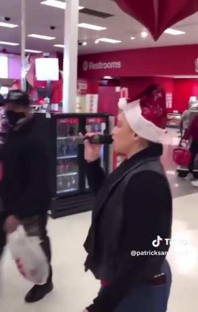 Woman sings Christmas song in the middle of a Target