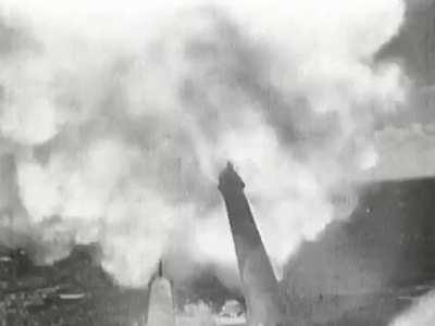 British Erebus-class monitor HMS Terror bombarding Italian positions in Bardia in Libya with her 15-inch guns in early January 1941