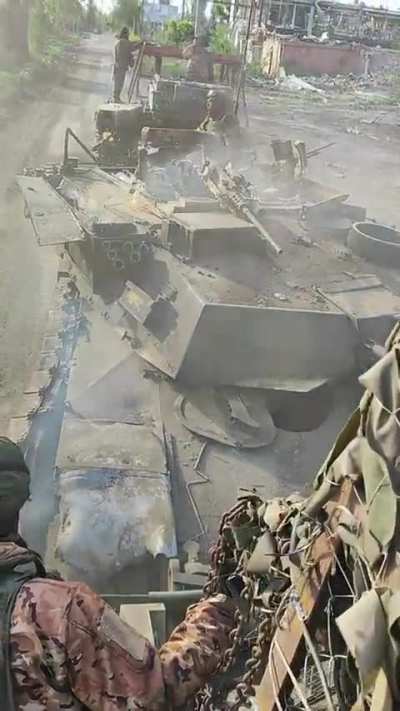 Russian troops tow a destroyed Ukrainian Abrams tank in the Avdiivka direction. Date and Location Unknown 