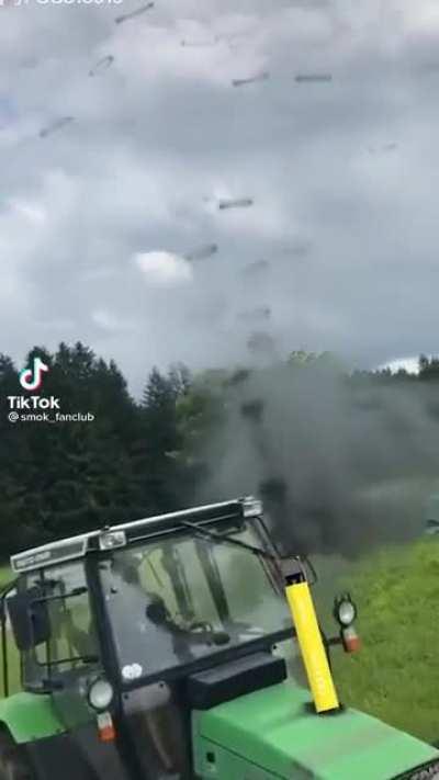 A tractor making perfect smoke rings from its exhaust pipe