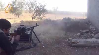 FSA fighter uses a PKM to suppress a sandbagged SAA checkpoint in Umm al-Mayazen - 10/17/2014