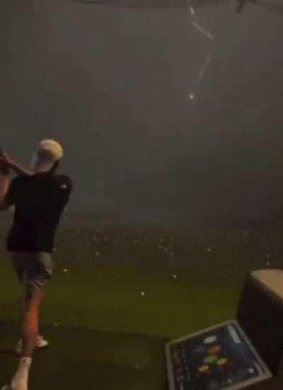 Lightning hitting a golf ball in mid air