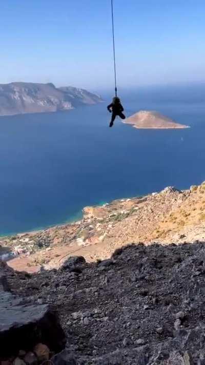 Little kid getting comfortable on a climbing rope