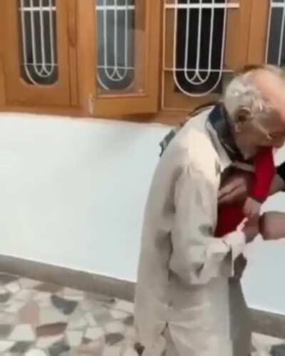 Elderly man overjoyed to meet great grand child, and forgets about his own pain.....