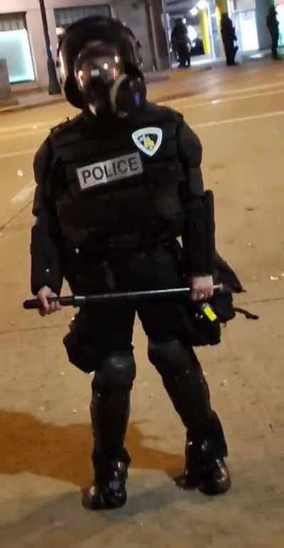 Female cop dealing with mens only riot gear.