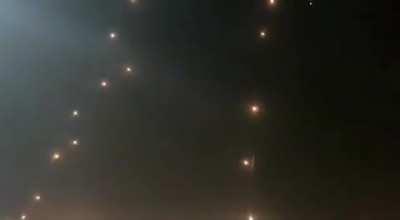 A barrage of dozens of rockets being intercepted by Iron Dome.