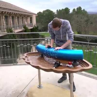 James Hancock playing a hydraulophone outside the music building at Stanford University