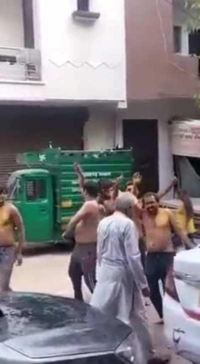 People (hooligans) harassing an elderly while celebrating Holi in India.