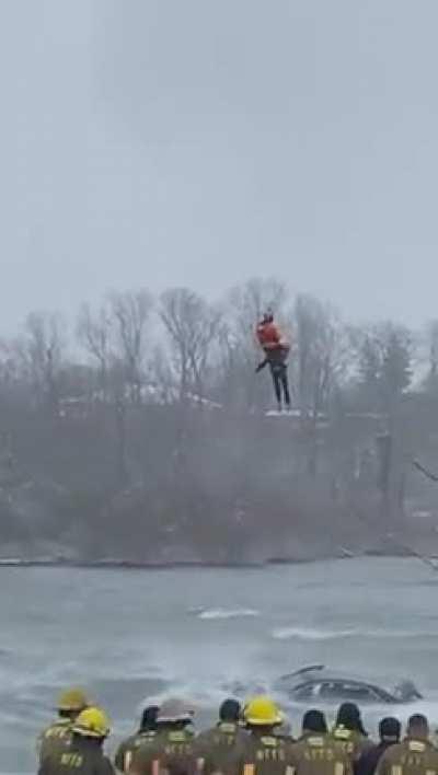 Coast Guard swimmer recovers body trapped inside vehicle stuck at the edge of Niagara Falls. NSFW.