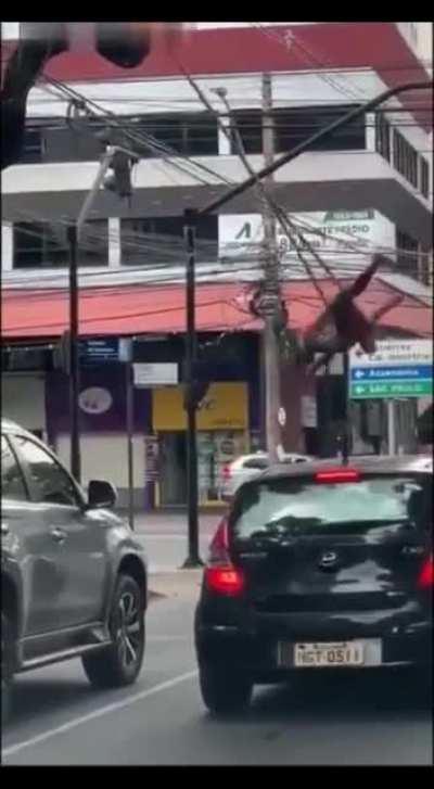 Spiderman Swinging on Busy Intersection