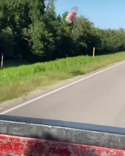 Empty bottle being dragged along a car by aerodynamic drag