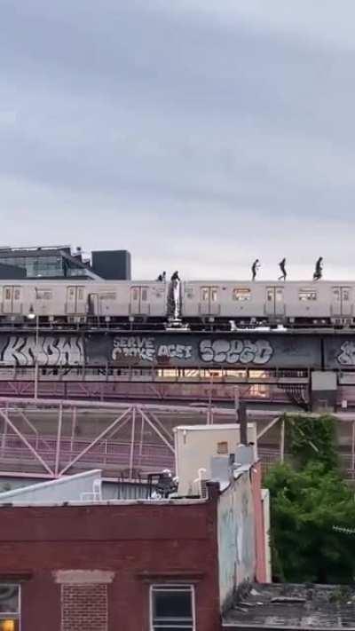 People walking on top of the train