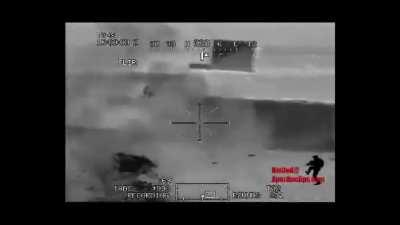 An AH-64D Apache Gunship engages insurgents in a Truck with a Hellfire in Iraq. The Apache scores a direct hit but some insurgents manage to run into a nearby building. (Date Unknown)