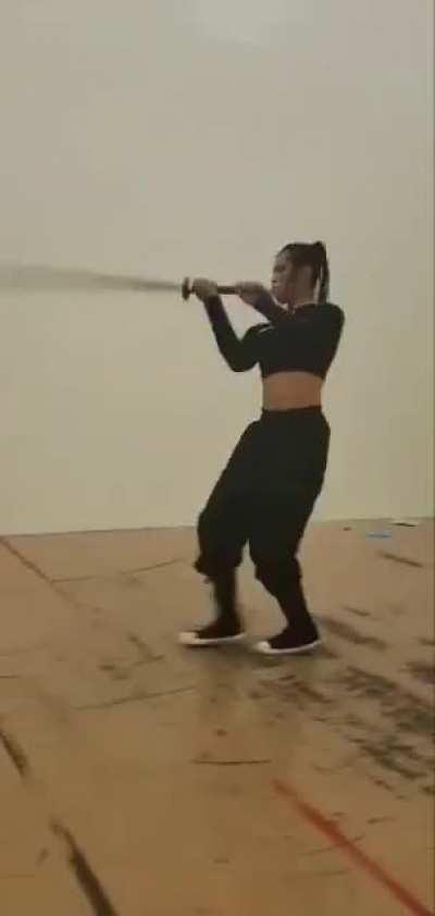 Kung fu Black girl with really big heavy Chinese sword miao dao or grain leaf sword