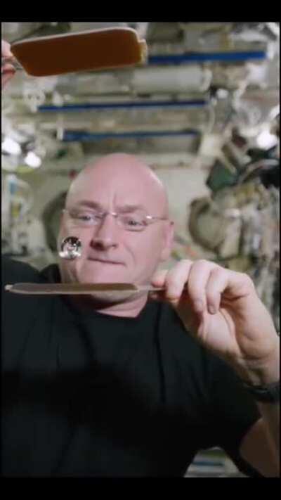 Scott Kelly aboard the international space station plays ping pong with a ball of water and two hydrophobic paddles