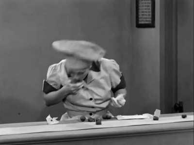 Lucille Ball and Vivian Vance struggle to keep up with a chocolate conveyer belt in a candy factory, in a 1952 episode of 