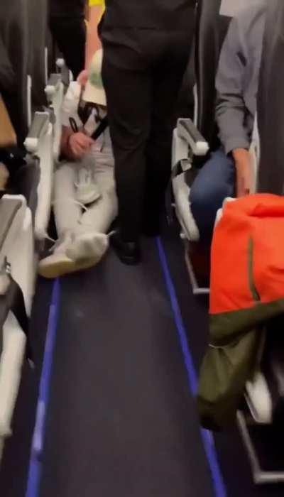 Drunk and obnoxious passenger picks a fight with a boxer on a plane and finds out