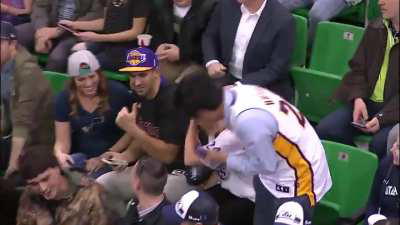 Kobe tosses his sleeve to a fan then another fan steals it