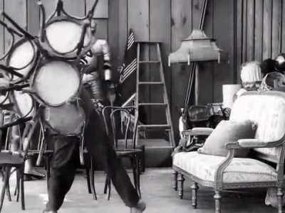 Here's Charlie Chaplin somehow carrying 11 chairs at once in 'Behind the Screen' (1916)