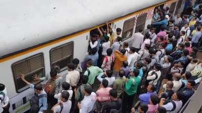 Rush hour in Mumbai local trains, flooded with people.