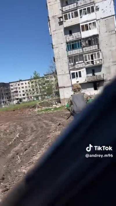 Ukrainian soldiers walking the streets yesterday in Bakhmut, sounds of combat between the Ukrainian and Russian armies can be heard in the background