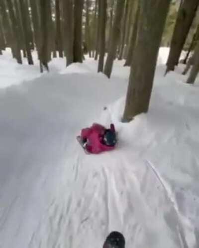 Two-Year-old skiing down a difficult slope with her Dad