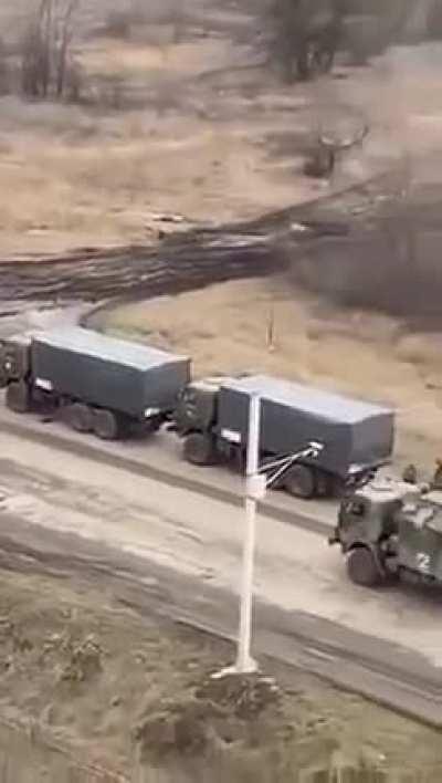 Long Column of Russian (Z Markings on the back of Kamaz in the first seconds of the video) BM-21s, 2S3 Akatsiya(One painted with a white stripe) and MBTs patiently waiting next to a Gas Station.