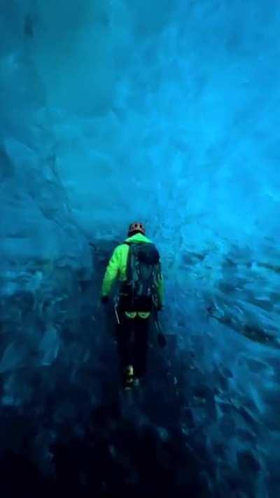 Walking though a blue ice crevasse in Iceland