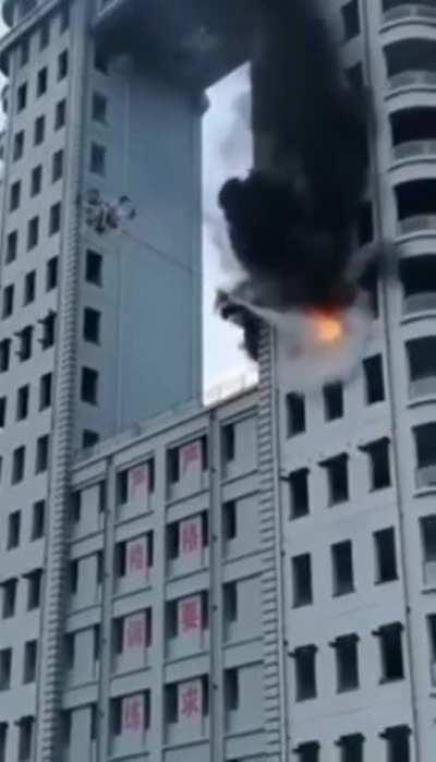 Drone putting out a blazing high-rise building fire.