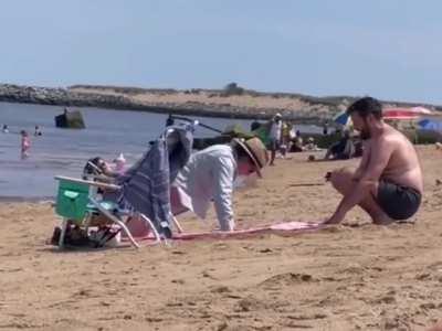 This guy dug a hole in the sand so his pregnant partner could lie in her stomach