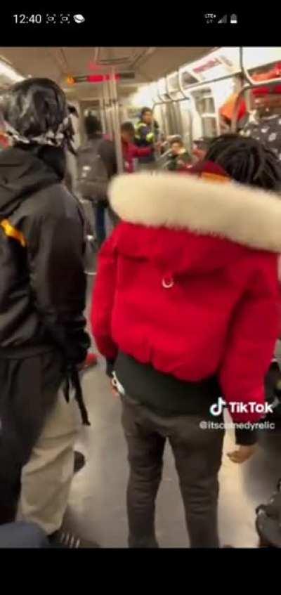 Guy in a Santa-merch elbow dropping a sleeping guy.