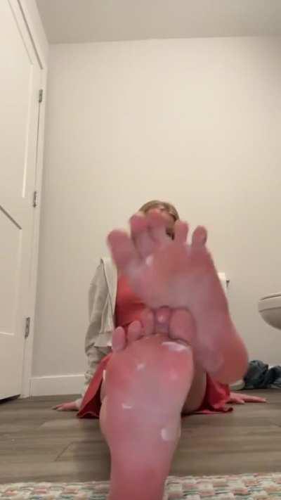 Pretty blonde teen lotions feet