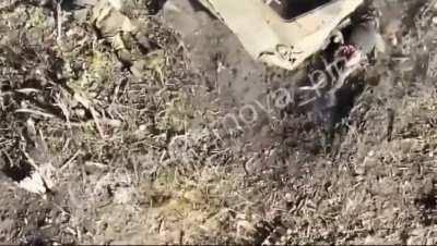 Two russians hiding behind destroyed APC try to shoot down incoming Ukrainian kamikaze drone