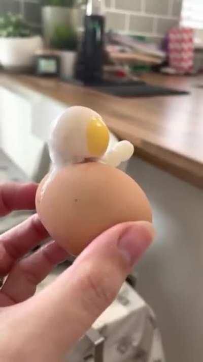 This boiled egg that came out looking like an astronaut waving their arm.