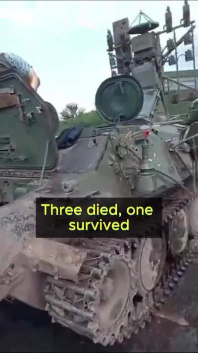 Russian servicemen wash the remains of their comrades from a combat vehicle for further use in battle.