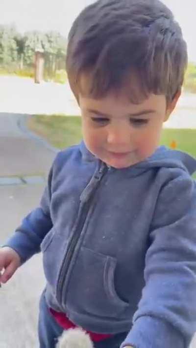 My cousin playing with a dandelion