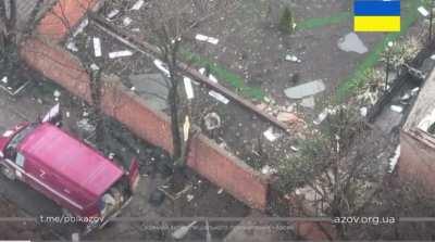 Azov soldier throws grenades over a wall at Russian soldiers looting houses. Mariupol. March 2022