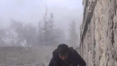 Freedom Dawn Brigade fighter just chucks an improvised explosive over a wall towards Syrian Army positions - Bustan al-Basha - 4/16/2014