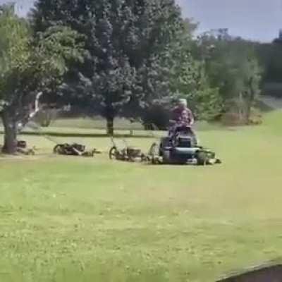 This guy has rigged up a whole army of mowers to keep his lawn looking great