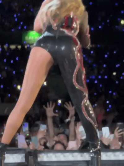 Taylor bending over in latex outfit 