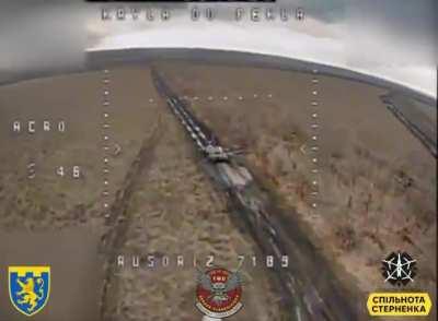 Russian tank gunner lowers his head in the turret hatch, to protect him from a FPV drone hit.