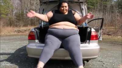 Brianna with her huge body in small car