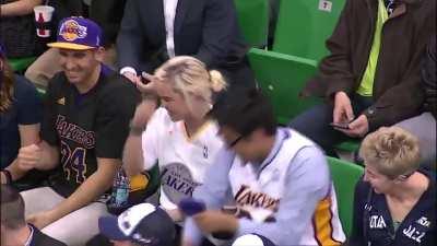 When Kobe throws his sleeve to one fan, another takes it.