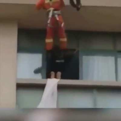 Fireman kicking suicidal people from the window