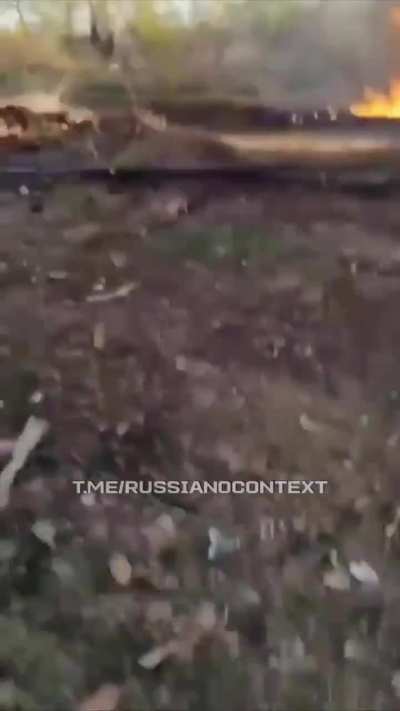 A Russian soldier records his burning vehicle as a consequence of a Ukrainian FPV drone strike