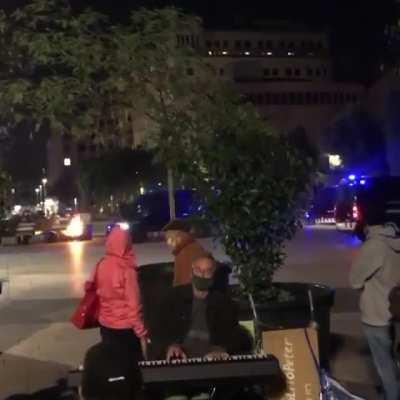 Piano player calmly keeps on playing during a heated protest in Barcelona