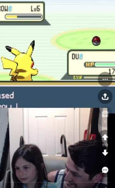 A young girl playing Pokemon with her dad for the first time and catching her first Pokemon